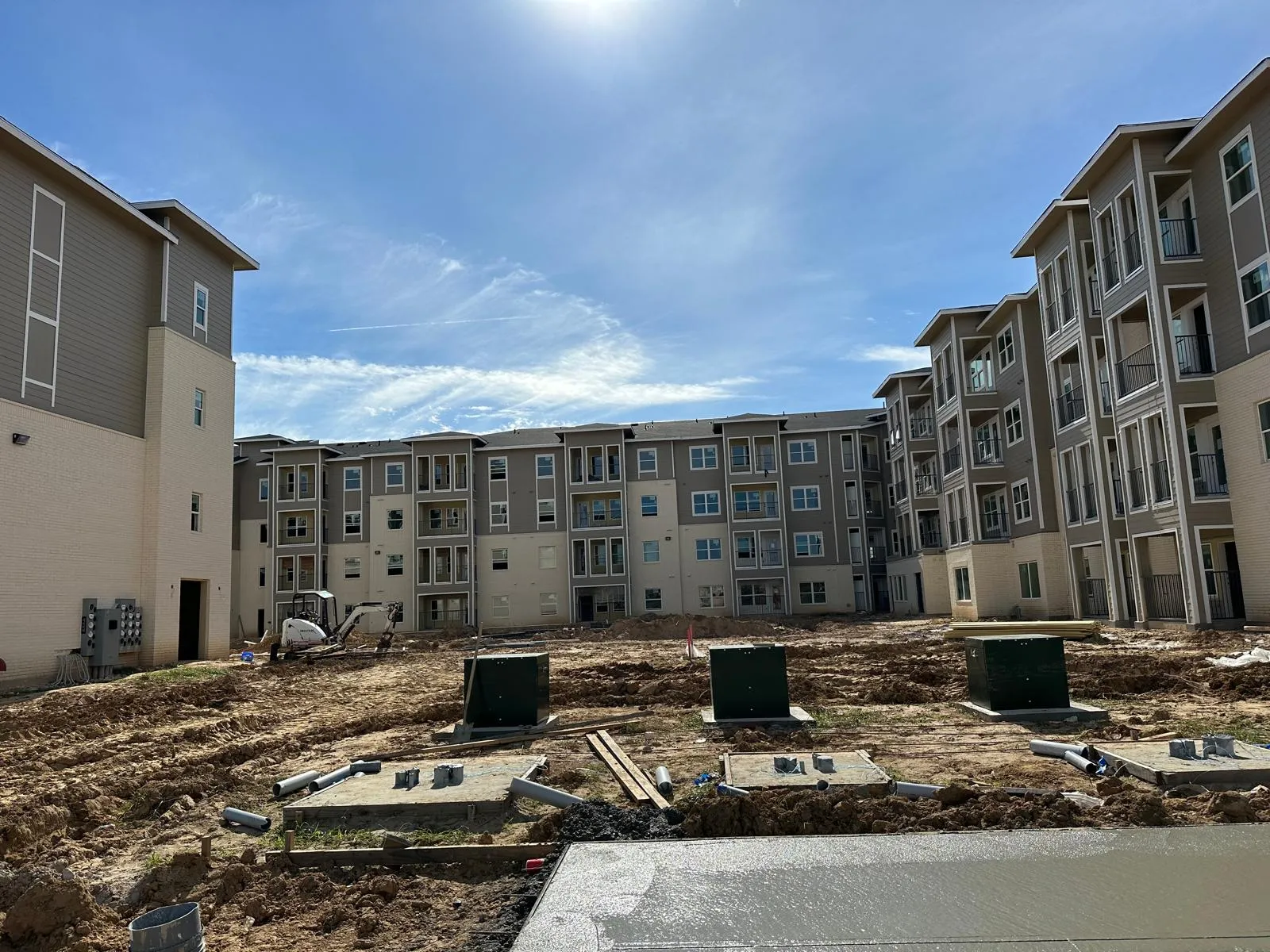 Four-story multifamily community with a masonry base under construction